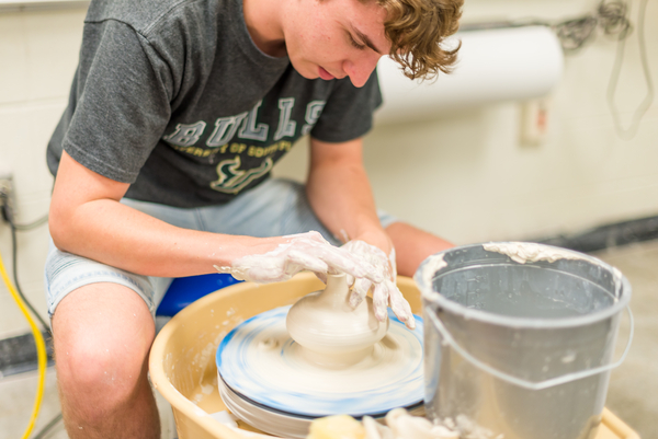 Student spinning pottery