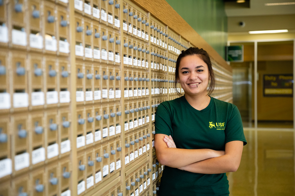 Student in front of mailboxes