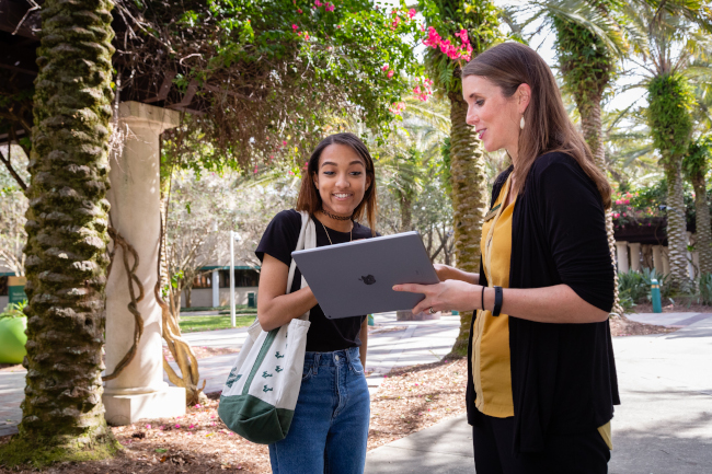 Staff showing student information on tablet