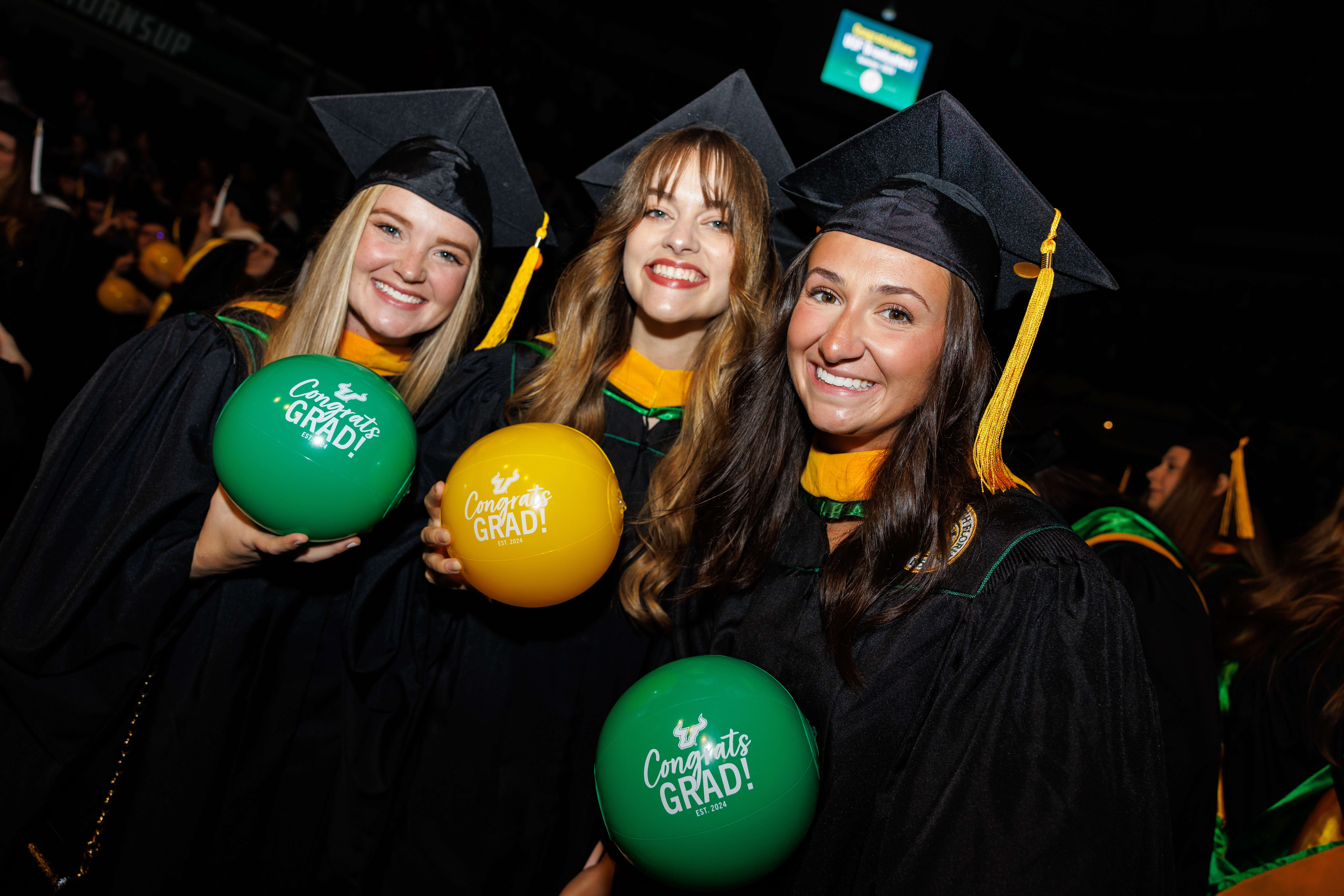 Three women in graduation regalia