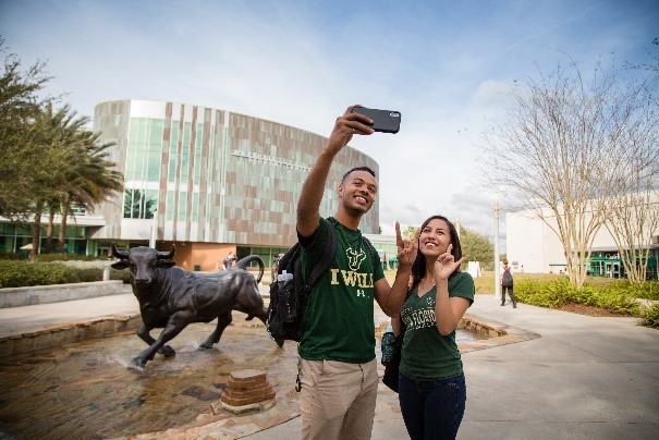 Students taking a picture near the stampeding bulls